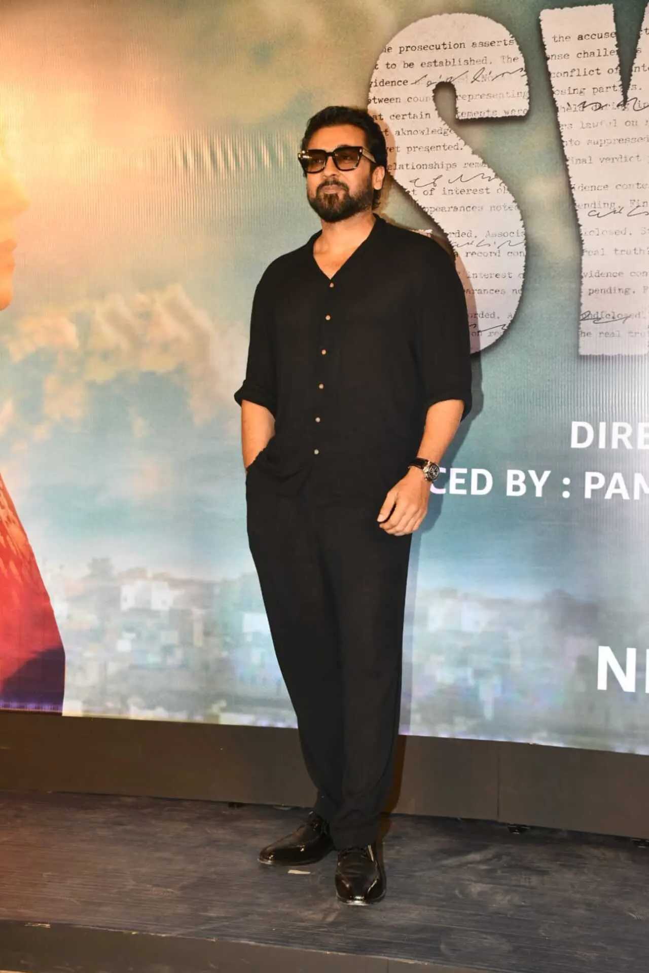 Suriya looked dapper in an all-balck outfit, perfectly complemented with black shoes and sunglasses. Suriya looked dapper in an all-balck outfit, perfectly complemented with black shoes and sunglasses.